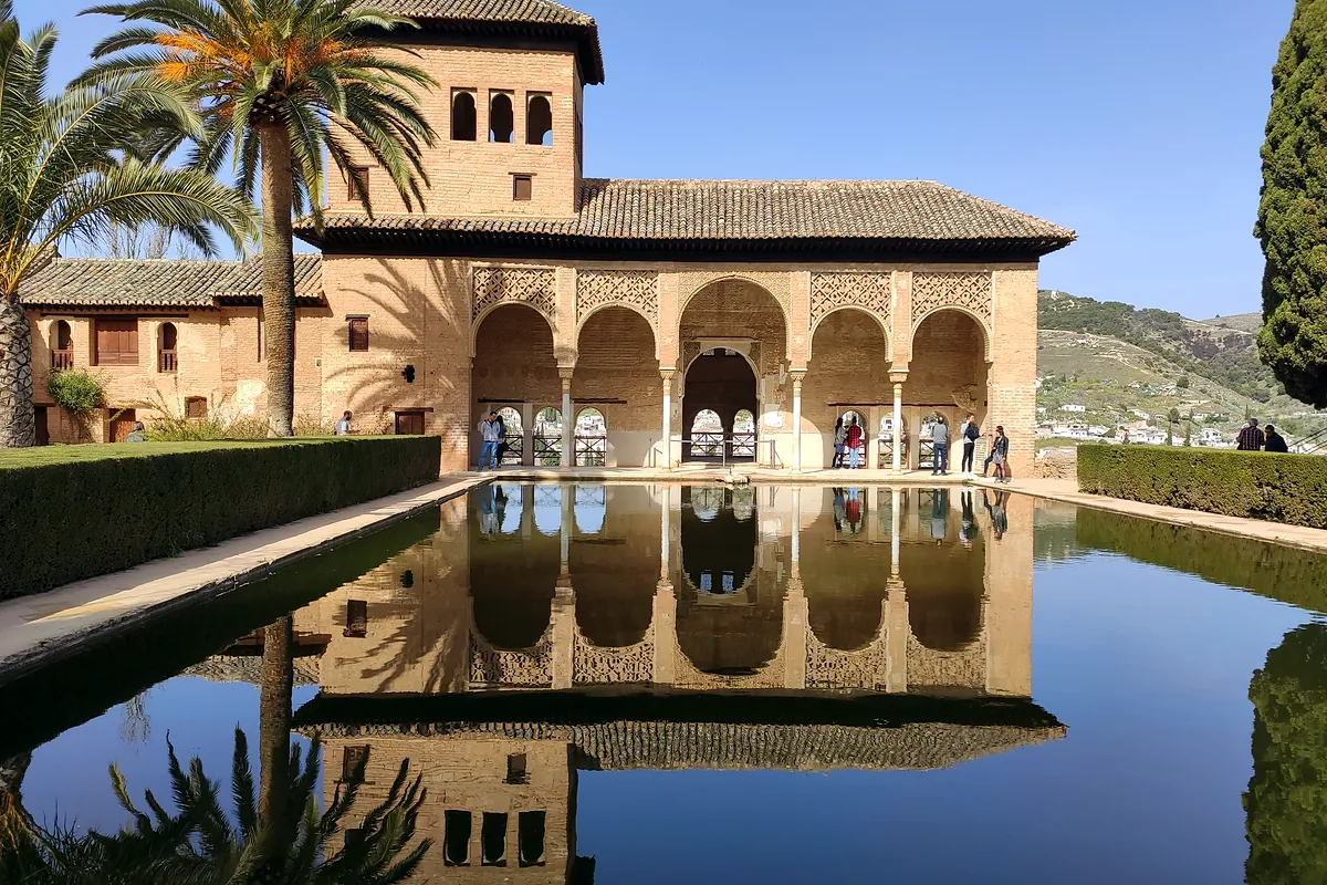 The Partal palace and its pool, among palm trees, in the Alhambra