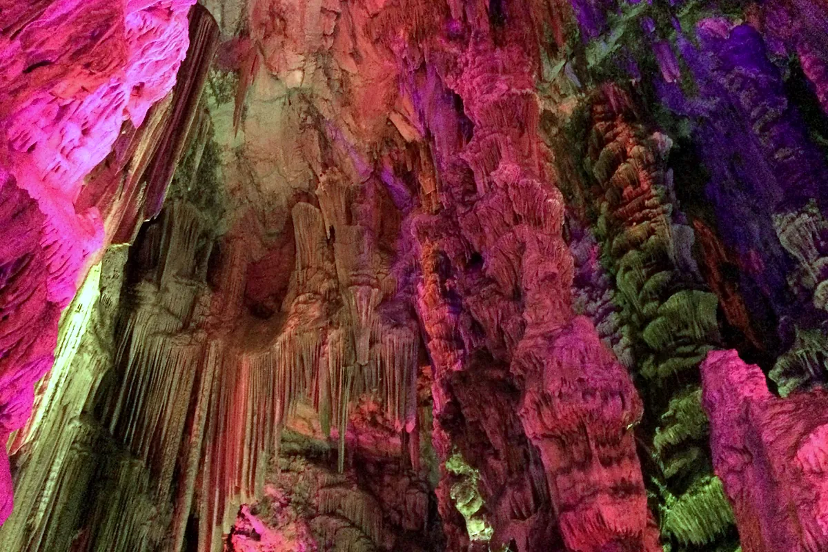 The lit-up limestone formations inside St Michael's Cave, Gibraltar