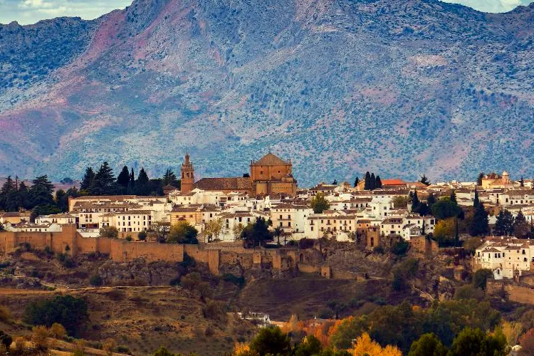 The old town of Ronda above its walls, with the mountains behind