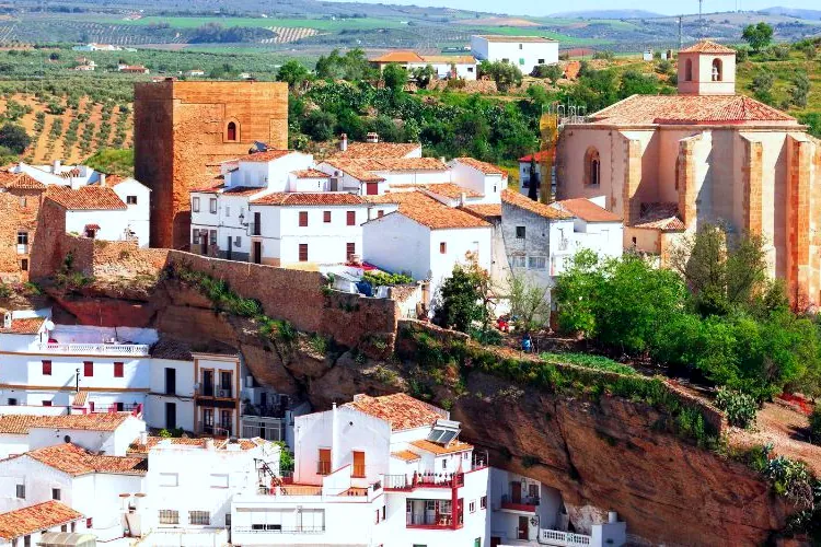 Setenil de las Bodegas, with its castle tower and church above the houses